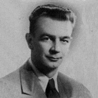 Richard Izard Smiling man in a suit and tie